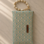 Triangular pattern bag with beaded twisted handle
